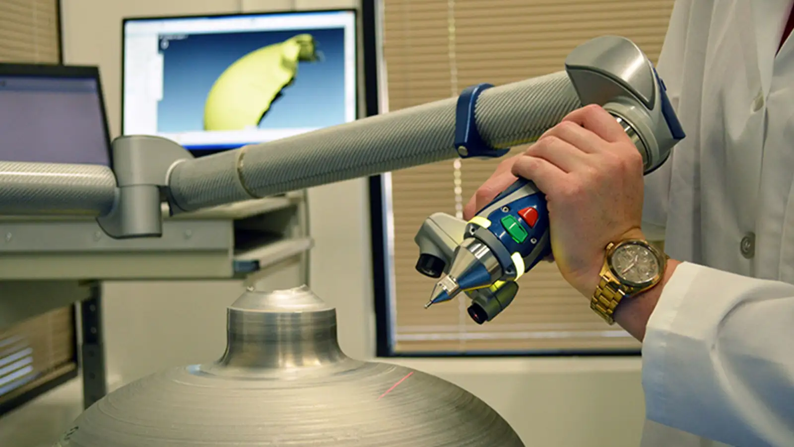 Engineer using a 3D scanning arm to measure a pressure vessel prototype, ensuring precision and compliance with aerospace and defense testing standards.