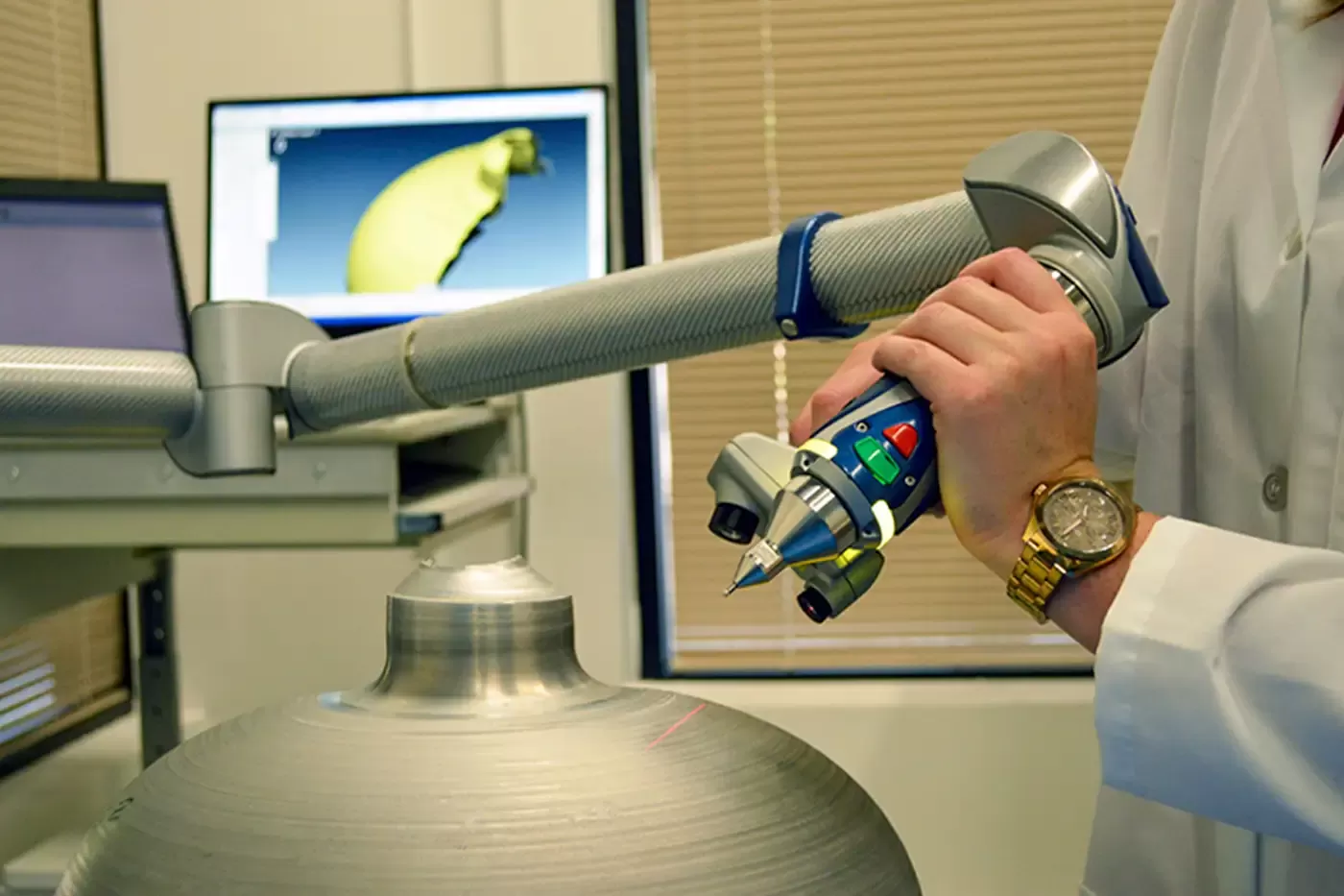 Engineer using a 3D scanning arm to measure a pressure vessel prototype, ensuring precision and compliance with aerospace and defense testing standards.